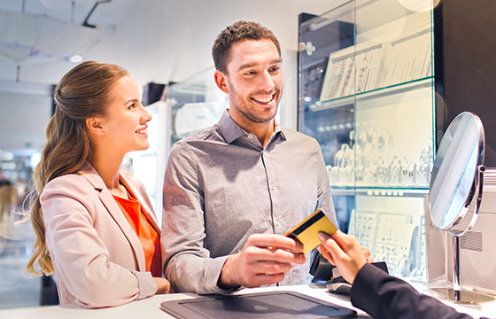 young caucasian couple making a purchase at a jewelry store