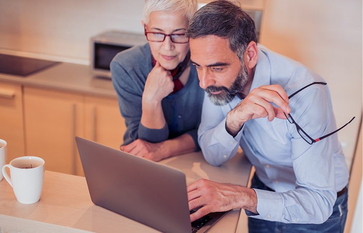 senior couple looking at computer