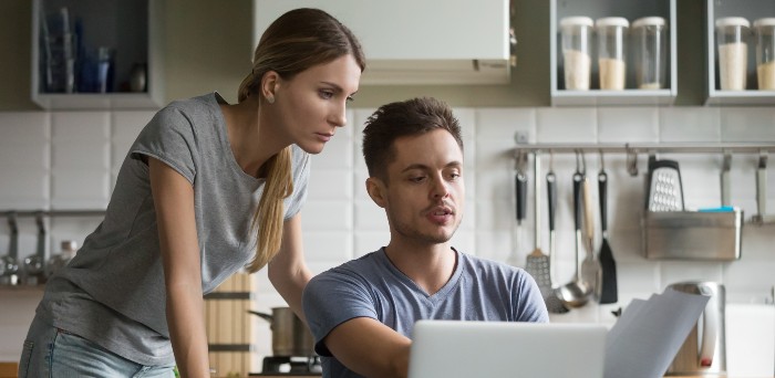 couple at table learning about Unemployement fraud