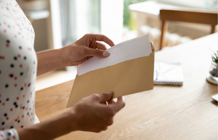 women opening a piece of mail