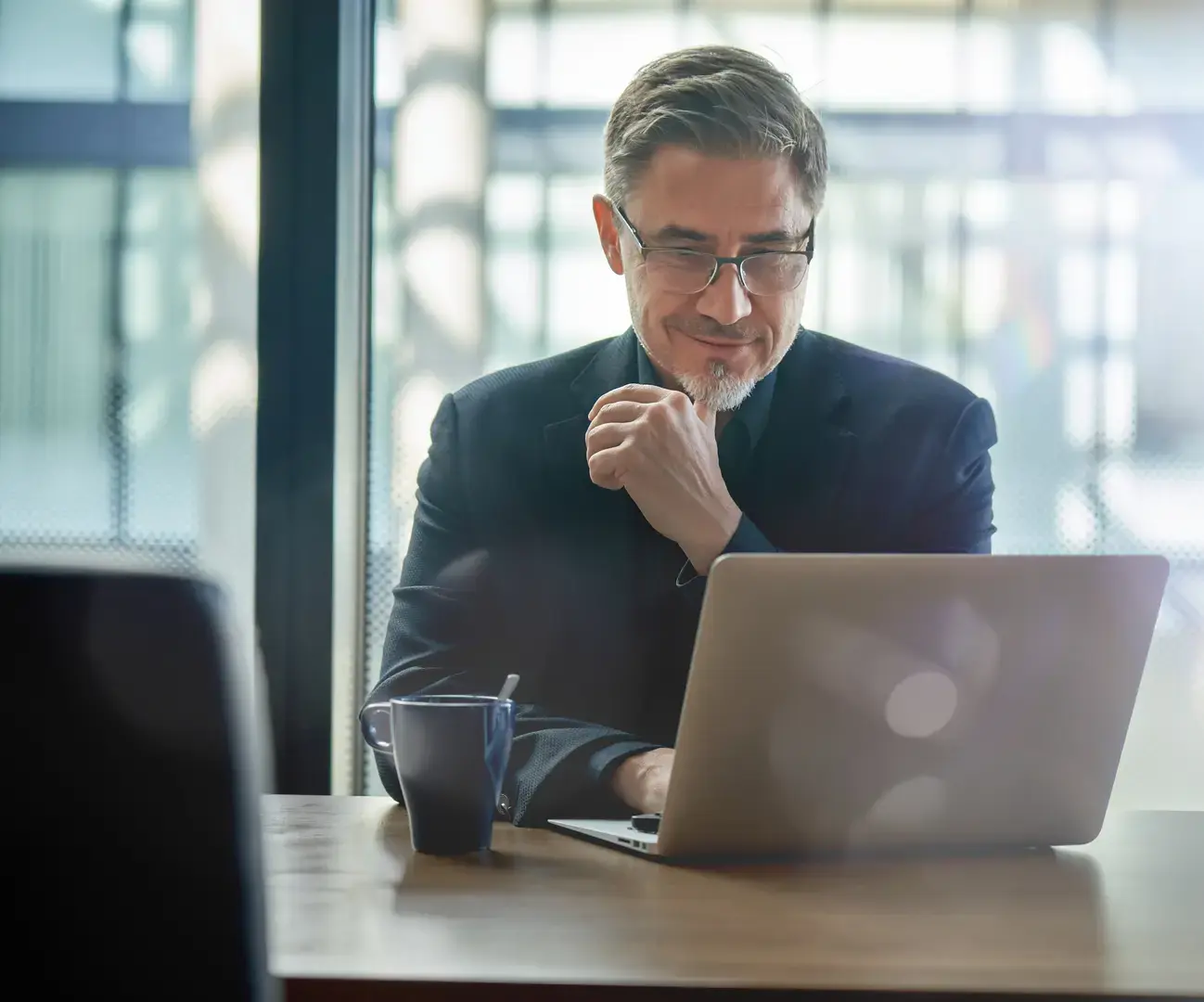 Man works on laptop at coffee shop