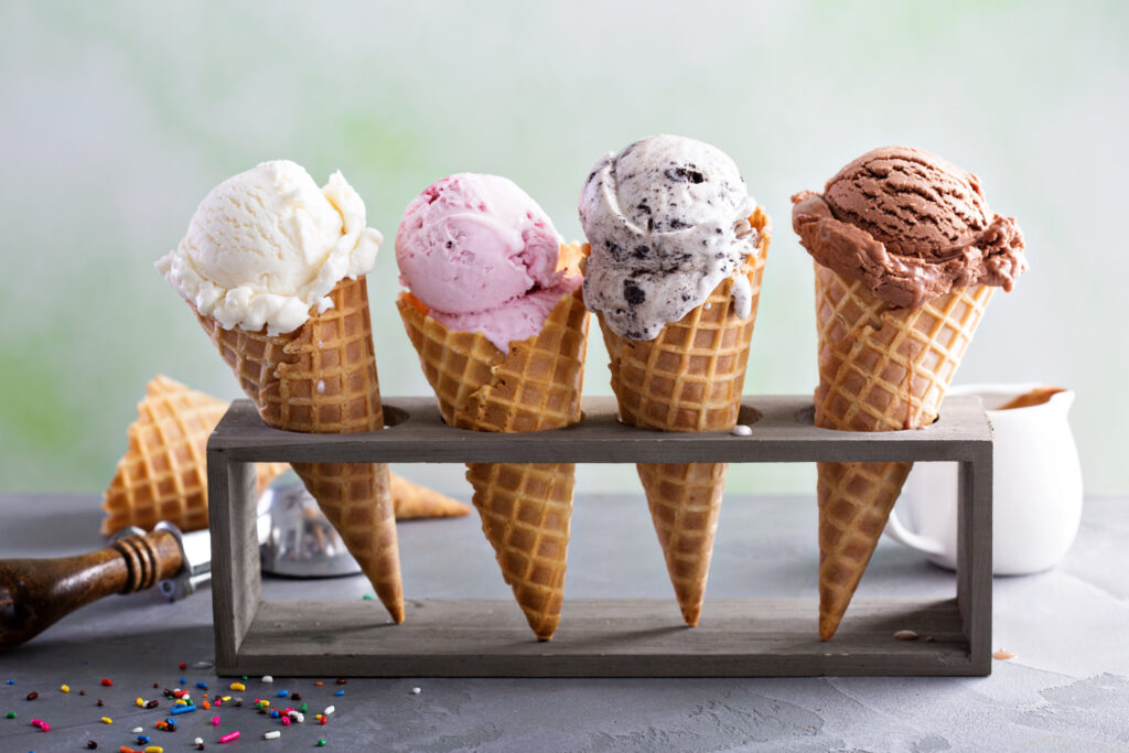 Four ice cream cones sit in a holder on a table