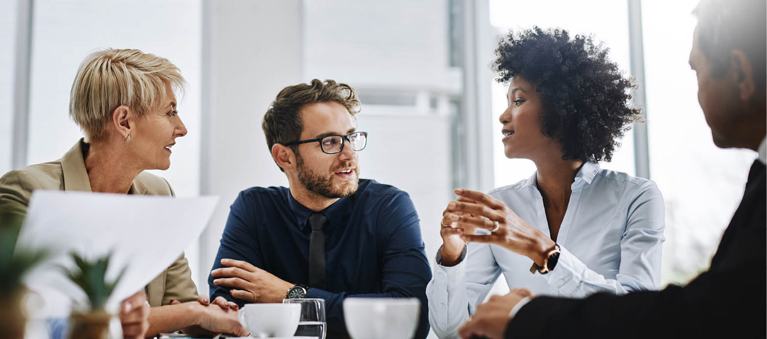 Group of professionals talking at a table.
