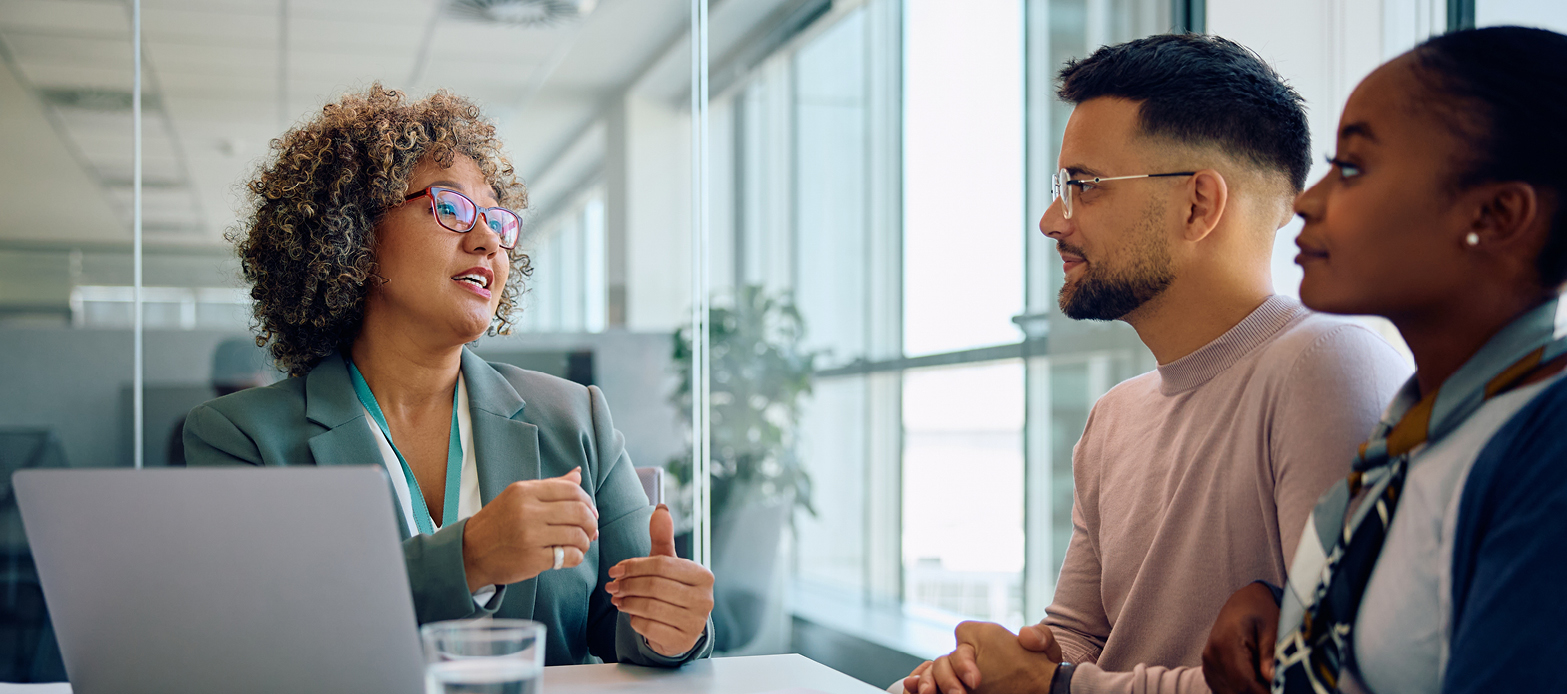 A man and a woman sitting at a table talking to an expert